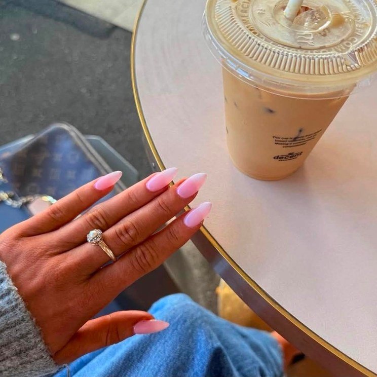 Long pink almond nails on a coffee run